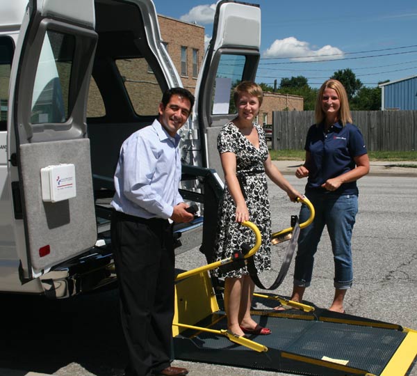 Carrie Morton from Ricon Corporation (at right) demonstrates the wheelchair lift to Steve Camilleri – Executive Director, Center for the Homeless and Angela Willson – Director of Center Initiatives.